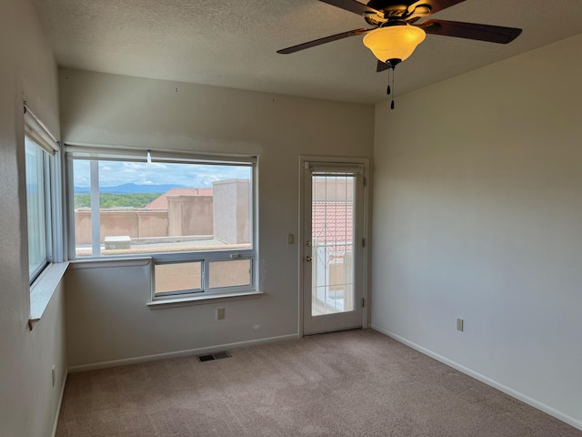 5400 Pegasus Dr NW, Albuquerque, NM 87120 - empty room with carpet floors, healthy amount of natural light, ceiling fan, and a textured ceiling