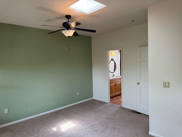 5400 Pegasus Dr NW, Albuquerque, NM 87120 - unfurnished bedroom with carpet flooring, a skylight, connected bathroom, and a ceiling fan