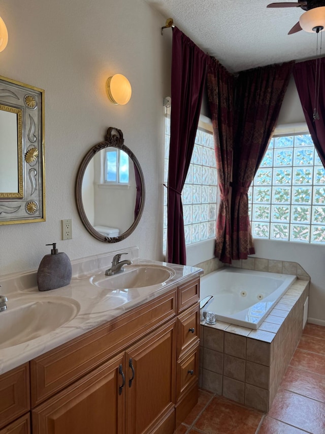 5400 Pegasus Dr NW, Albuquerque, NM 87120 - full bath featuring plenty of natural light, double vanity, a jetted tub, ceiling fan, and a textured ceiling