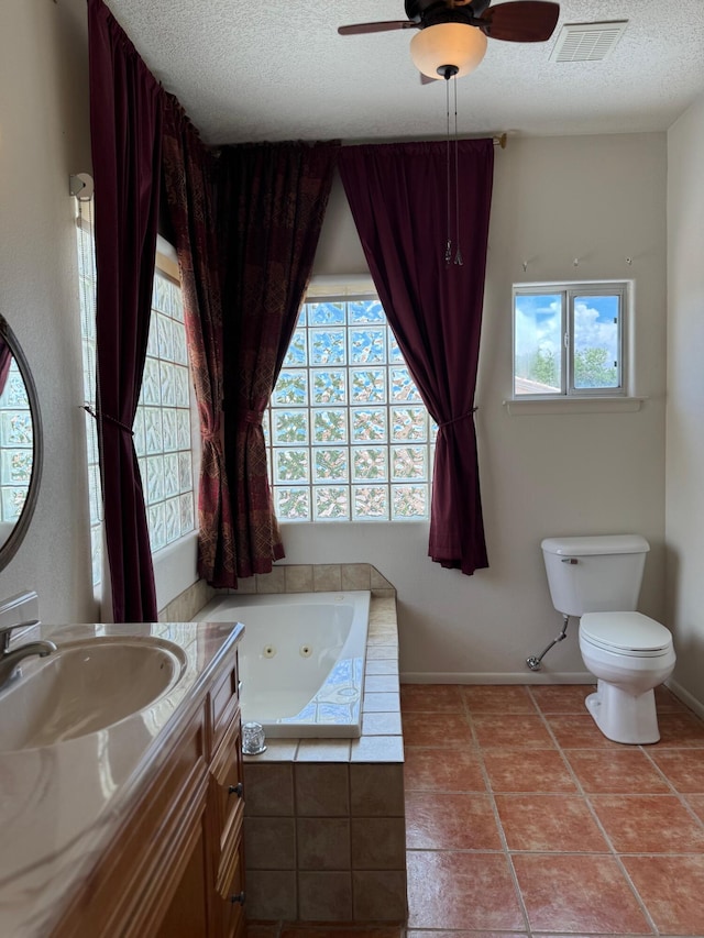 5400 Pegasus Dr NW, Albuquerque, NM 87120 - bathroom featuring a jetted tub, healthy amount of natural light, a textured ceiling, vanity, and a ceiling fan