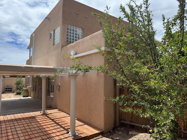 5400 Pegasus Dr NW, Albuquerque, NM 87120 - view of side of home featuring stucco siding and a patio