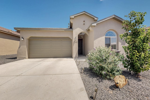 4293 Crowned Eagle Loop NE, Rio Rancho, NM 87144 - view of front of property featuring an attached garage, stucco siding, and concrete driveway