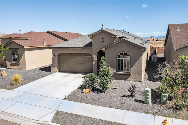 4293 Crowned Eagle Loop NE, Rio Rancho, NM 87144 - view of front of house with a garage, stucco siding, driveway, and a shingled roof