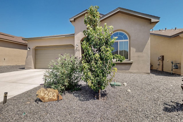 4293 Crowned Eagle Loop NE, Rio Rancho, NM 87144 - view of front of home with stucco siding, an attached garage, and concrete driveway