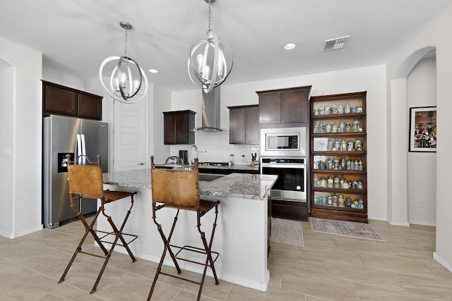 4293 Crowned Eagle Loop NE, Rio Rancho, NM 87144 - kitchen with appliances with stainless steel finishes, a chandelier, dark brown cabinets, light stone counters, and recessed lighting