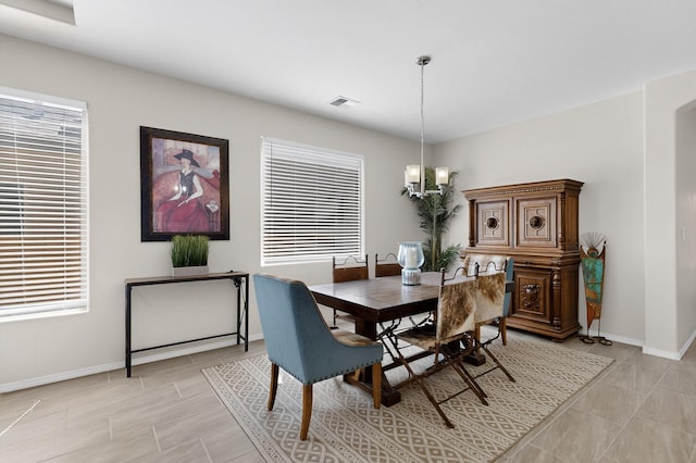 4293 Crowned Eagle Loop NE, Rio Rancho, NM 87144 - dining space with baseboards and a chandelier