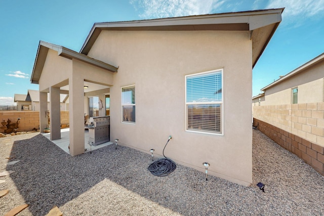 4293 Crowned Eagle Loop NE, Rio Rancho, NM 87144 - back of house featuring a fenced backyard, stucco siding, and a patio area