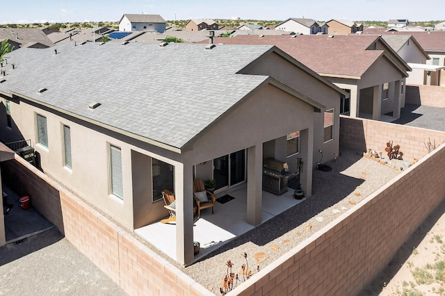 4293 Crowned Eagle Loop NE, Rio Rancho, NM 87144 - rear view of house featuring a shingled roof, a residential view, stucco siding, and a patio area
