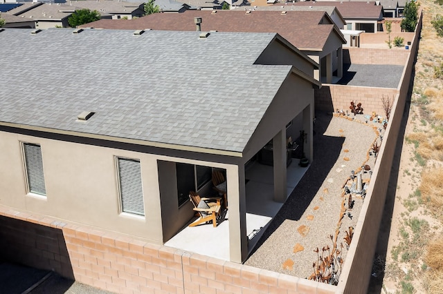 4293 Crowned Eagle Loop NE, Rio Rancho, NM 87144 - back of property with a shingled roof, a residential view, and a patio