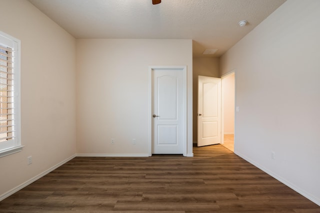 959 Salt Cedar Ct, Bernalillo, NM 87004 - unfurnished bedroom with dark wood finished floors, a textured ceiling, and a ceiling fan