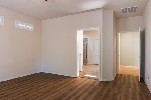959 Salt Cedar Ct, Bernalillo, NM 87004 - unfurnished bedroom with dark wood-style floors and a textured ceiling