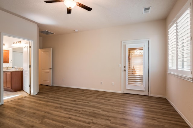 959 Salt Cedar Ct, Bernalillo, NM 87004 - unfurnished bedroom with wood finished floors, ensuite bath, a textured ceiling, and a ceiling fan