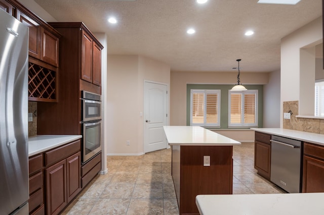 959 Salt Cedar Ct, Bernalillo, NM 87004 - kitchen featuring stainless steel appliances, recessed lighting, light countertops, a center island, and decorative backsplash