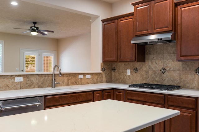 959 Salt Cedar Ct, Bernalillo, NM 87004 - kitchen featuring under cabinet range hood, stainless steel appliances, light countertops, ceiling fan, and decorative backsplash