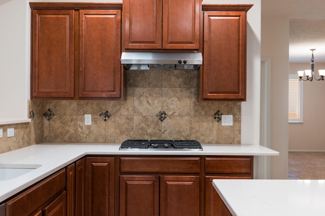 959 Salt Cedar Ct, Bernalillo, NM 87004 - kitchen featuring under cabinet range hood, stainless steel gas cooktop, light countertops, and backsplash