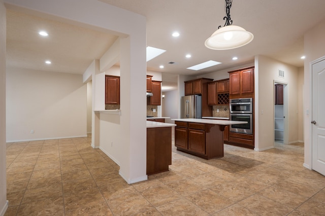 959 Salt Cedar Ct, Bernalillo, NM 87004 - kitchen featuring appliances with stainless steel finishes, light countertops, recessed lighting, a center island, and hanging light fixtures