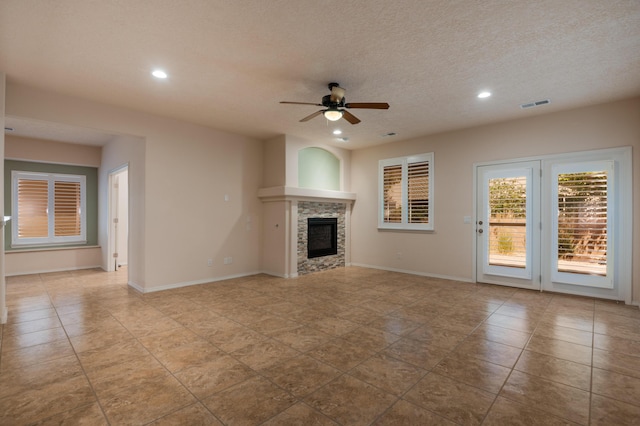 959 Salt Cedar Ct, Bernalillo, NM 87004 - unfurnished living room featuring ceiling fan, recessed lighting, a tiled fireplace, and a textured ceiling