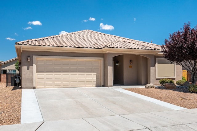 959 Salt Cedar Ct, Bernalillo, NM 87004 - mediterranean / spanish-style home featuring concrete driveway, stucco siding, a garage, and a tiled roof