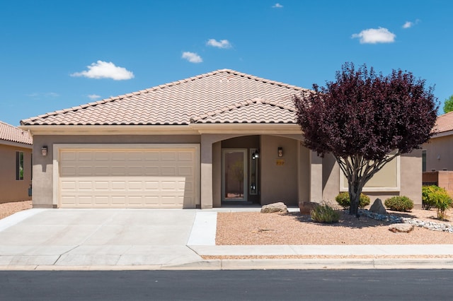 959 Salt Cedar Ct, Bernalillo, NM 87004 - view of front of house with stucco siding, driveway, an attached garage, and a tile roof