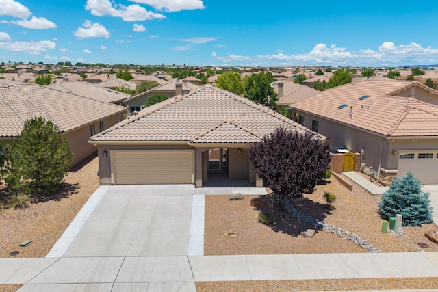 959 Salt Cedar Ct, Bernalillo, NM 87004 - view of front of property with a garage, driveway, a tiled roof, a residential view, and stucco siding