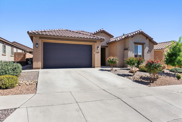 9015 Vista Dibujo Rd, Albuquerque, NM 87120 - mediterranean / spanish house with an attached garage, stucco siding, concrete driveway, and a tile roof