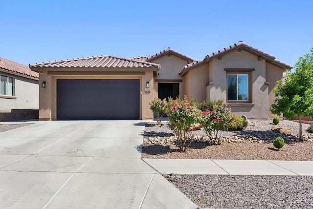 9015 Vista Dibujo Rd, Albuquerque, NM 87120 - mediterranean / spanish-style home featuring an attached garage, stucco siding, driveway, and a tile roof
