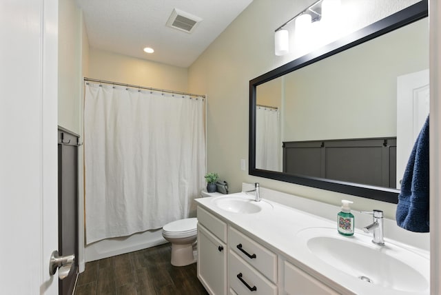 9015 Vista Dibujo Rd, Albuquerque, NM 87120 - bathroom featuring double vanity, wood finished floors, and shower / bath combo
