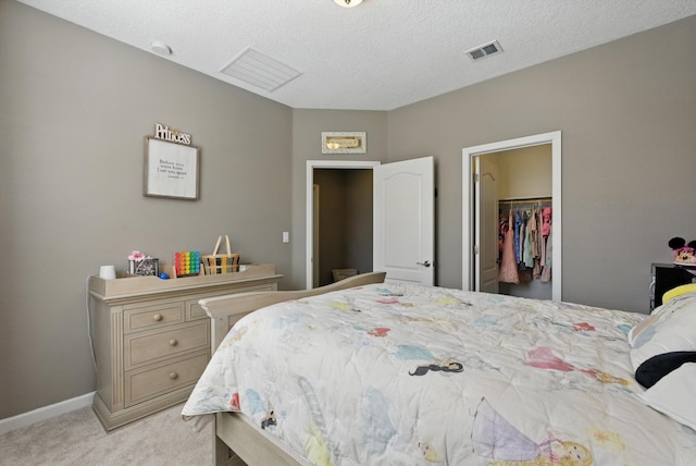 9015 Vista Dibujo Rd, Albuquerque, NM 87120 - bedroom with light colored carpet, a walk in closet, a closet, and a textured ceiling