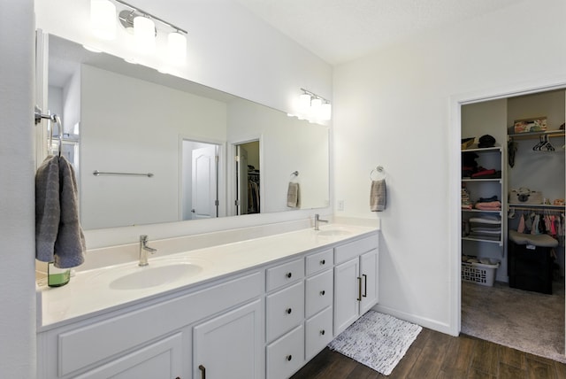 9015 Vista Dibujo Rd, Albuquerque, NM 87120 - full bathroom featuring double vanity, a walk in closet, and wood finished floors