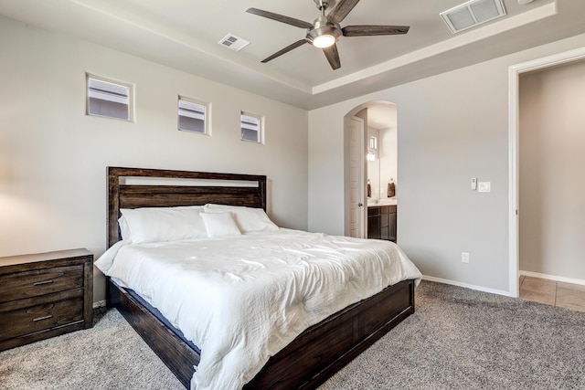 4236 Crowned Eagle Loop NE, Rio Rancho, NM 87144 - bedroom with arched walkways, a tray ceiling, ensuite bath, carpet, and a ceiling fan