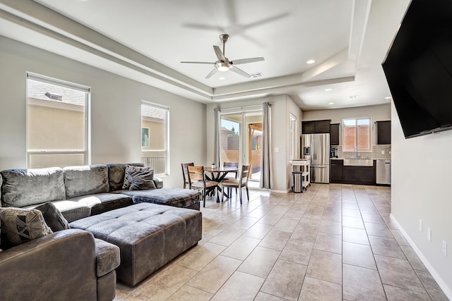 4236 Crowned Eagle Loop NE, Rio Rancho, NM 87144 - living area with a raised ceiling, ceiling fan, recessed lighting, and light tile patterned flooring