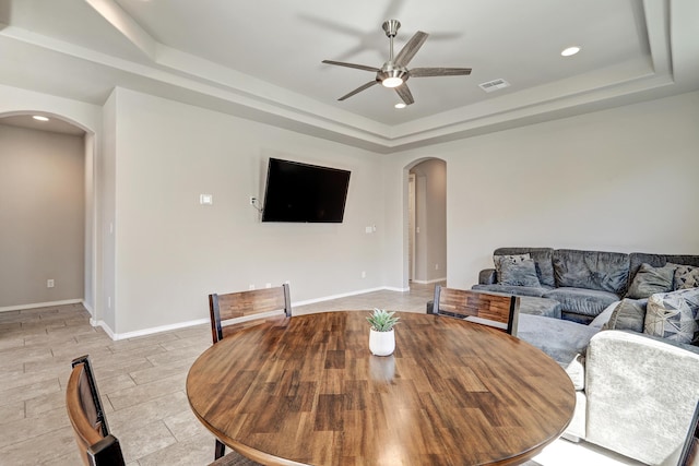 4236 Crowned Eagle Loop NE, Rio Rancho, NM 87144 - dining room with arched walkways, a raised ceiling, ceiling fan, recessed lighting, and light tile patterned floors