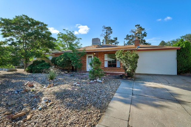 9418 Cordova Ave NE, Albuquerque, NM 87112 - ranch-style house with a chimney and concrete driveway