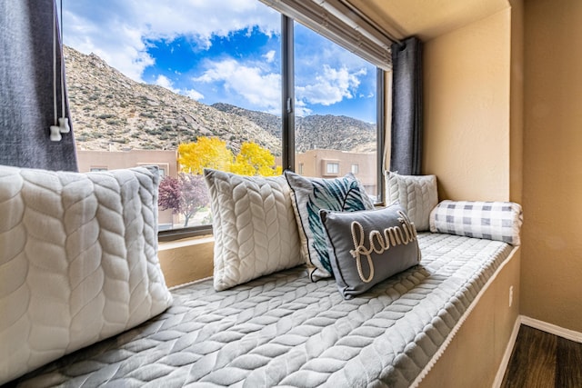 2900 Vista Del Rey NE Unit 18D, Albuquerque, NM 87112 - sitting room featuring a mountain view, wood finished floors, and a textured wall