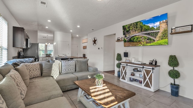 2404 Del Timbre Ln SW, Albuquerque, NM 87121 - living room with a textured ceiling, light tile patterned floors, and recessed lighting