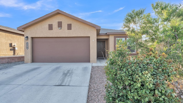 2404 Del Timbre Ln SW, Albuquerque, NM 87121 - view of front of property with stucco siding, an attached garage, and driveway