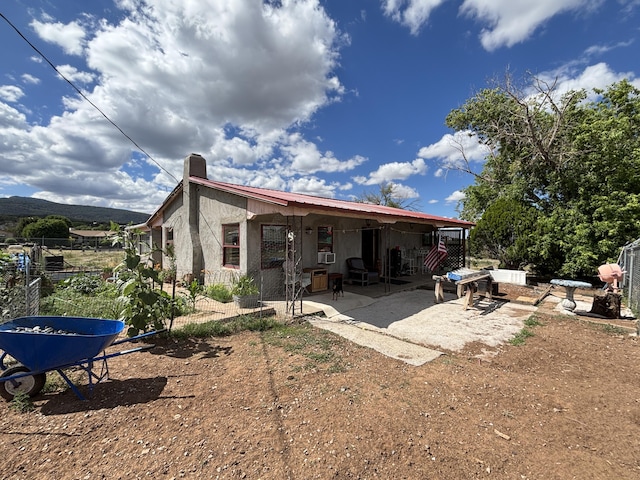 2 Bus Ln, Sandia Park, NM 87047 - back of property with a patio area and a chimney