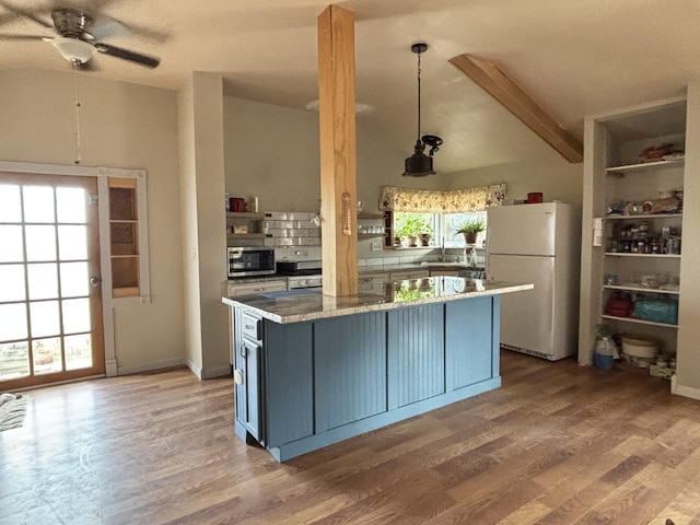 2 Bus Ln, Sandia Park, NM 87047 - kitchen featuring freestanding refrigerator, stainless steel microwave, stove, ceiling fan, and light wood-type flooring