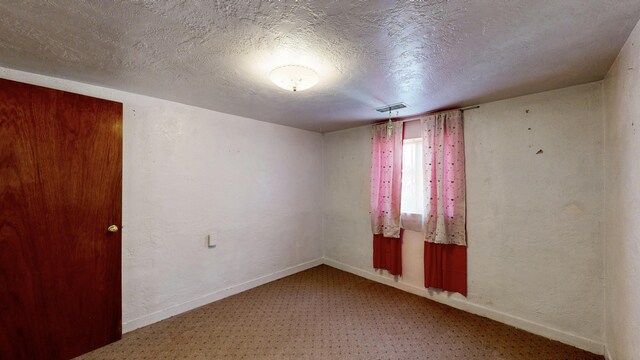 604 9th St SW, Albuquerque, NM 87102 - empty room with carpet flooring and a textured ceiling