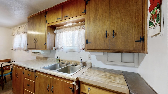 604 9th St SW, Albuquerque, NM 87102 - kitchen featuring light countertops, brown cabinets, and a textured ceiling