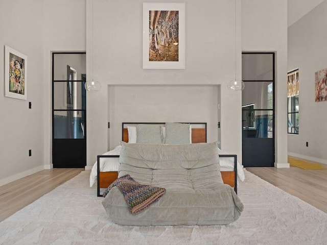400 Perea Ln, Corrales, NM 87048 - bedroom with wood finished floors and a towering ceiling