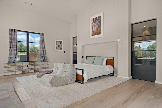 400 Perea Ln, Corrales, NM 87048 - bedroom featuring high vaulted ceiling and wood finished floors