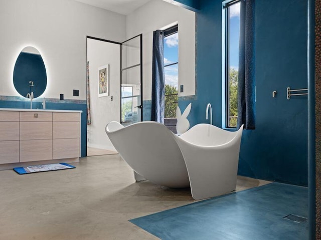 400 Perea Ln, Corrales, NM 87048 - bathroom featuring vanity, a freestanding bath, and concrete floors