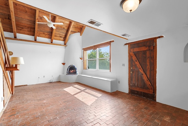 118 Sandia View Rd, Corrales, NM 87048 - unfurnished living room with brick flooring, wooden ceiling, a ceiling fan, and a warm lit fireplace