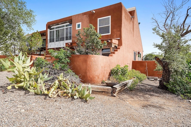 118 Sandia View Rd, Corrales, NM 87048 - view of front of house with stucco siding and a sunroom