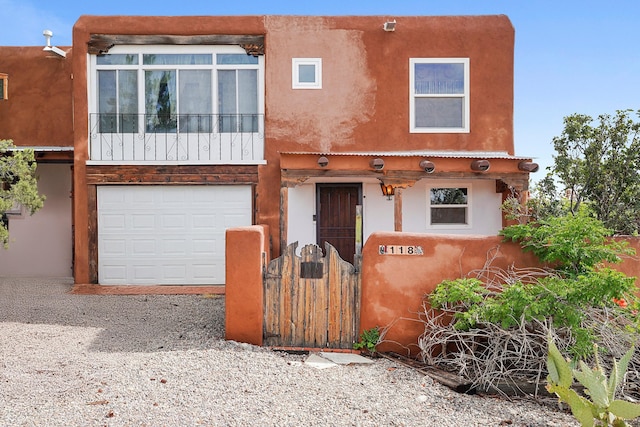 118 Sandia View Rd, Corrales, NM 87048 - view of front of property featuring stucco siding, a gate, and an attached garage