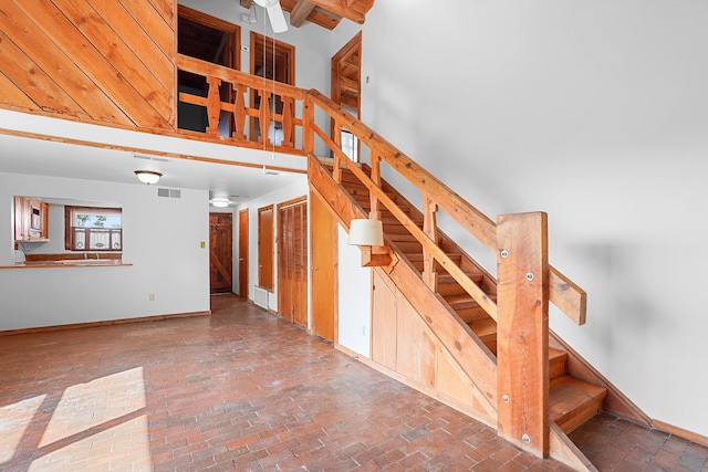 118 Sandia View Rd, Corrales, NM 87048 - staircase with brick flooring, ceiling fan, and a high ceiling