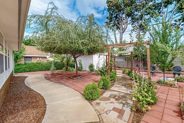 7719 Euclid Ave NE, Albuquerque, NM 87110 - fenced backyard with a patio and a pergola
