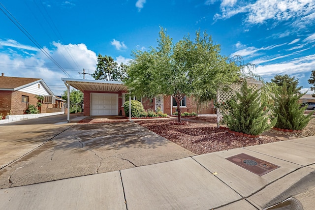 7719 Euclid Ave NE, Albuquerque, NM 87110 - view of front of property with an attached garage, brick siding, driveway, and a carport