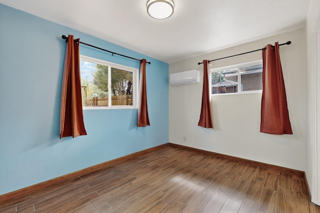 7719 Euclid Ave NE, Albuquerque, NM 87110 - unfurnished room with a wall unit AC, plenty of natural light, and wood finished floors